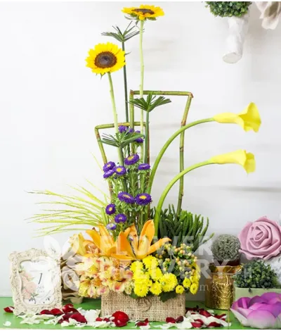 A Box of Mixed Yellow Flowers with Violet Mums
